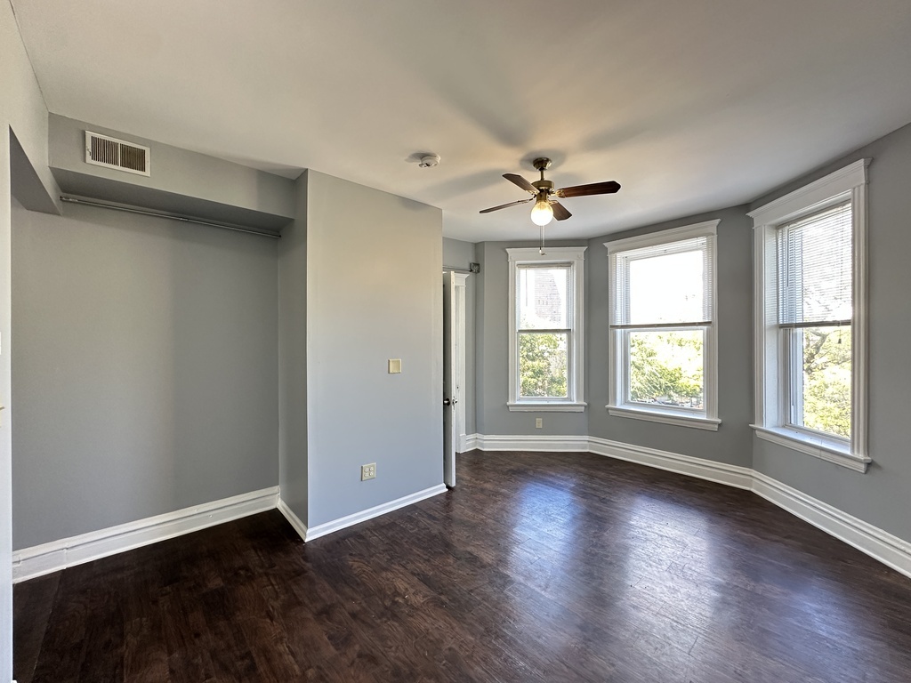 2713 West 16th Street, Unit 3 Chicago, IL 60608 - Photo 11 of 20 an empty room with wooden floor and windows
