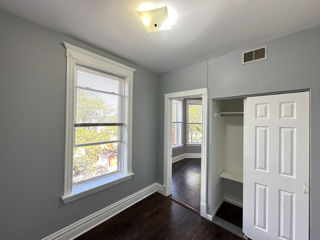 2713 West 16th Street, Unit 3 Chicago, IL 60608 - Photo 15 of 20 a view of an empty room with wooden floor and a window