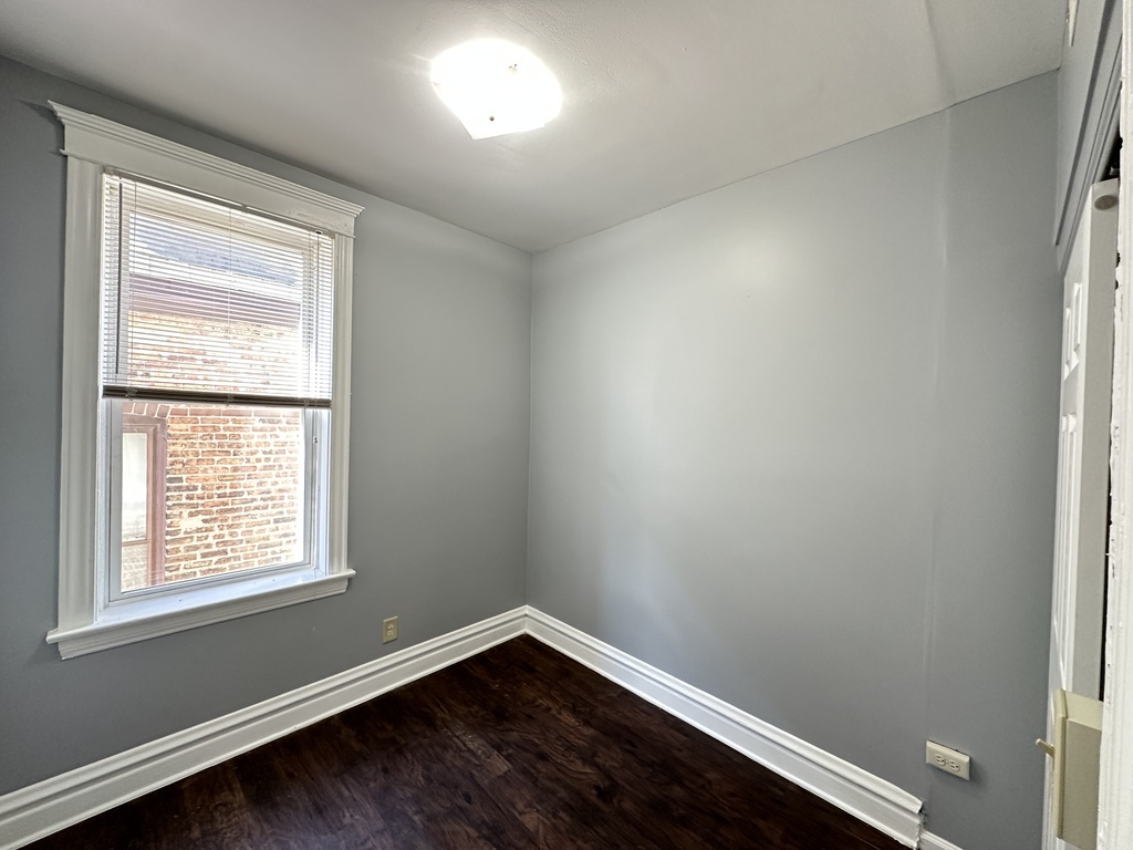 2713 West 16th Street, Unit 3 Chicago, IL 60608 - Photo 18 of 20 an empty room with wooden floor and windows
