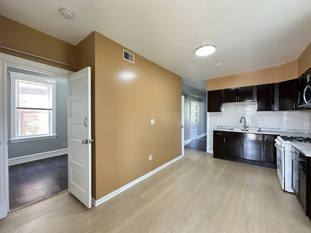 a view of a kitchen with a sink and a stove top oven