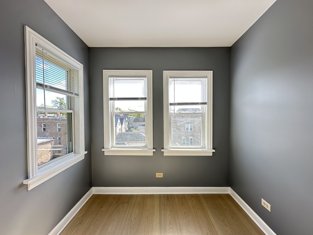 2713 West 16th Street, Unit 3 Chicago, IL 60608 - Photo 9 of 20 an empty room with wooden floor and windows