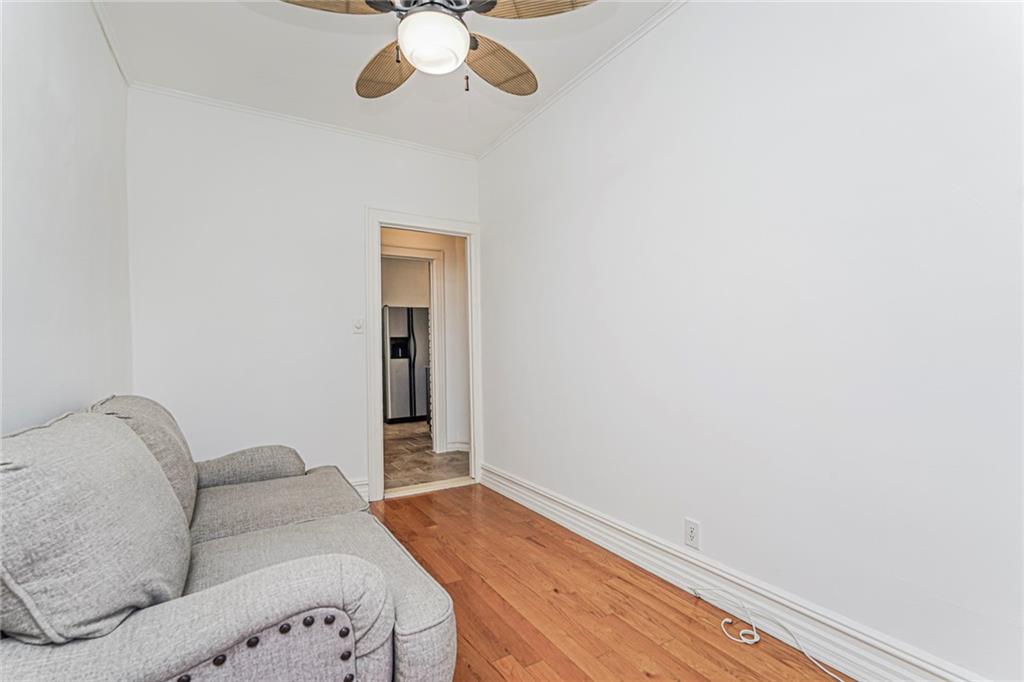 106 Village Road South Brooklyn, NY 11223 - Photo 21 of 42 a living room with furniture and a chandelier