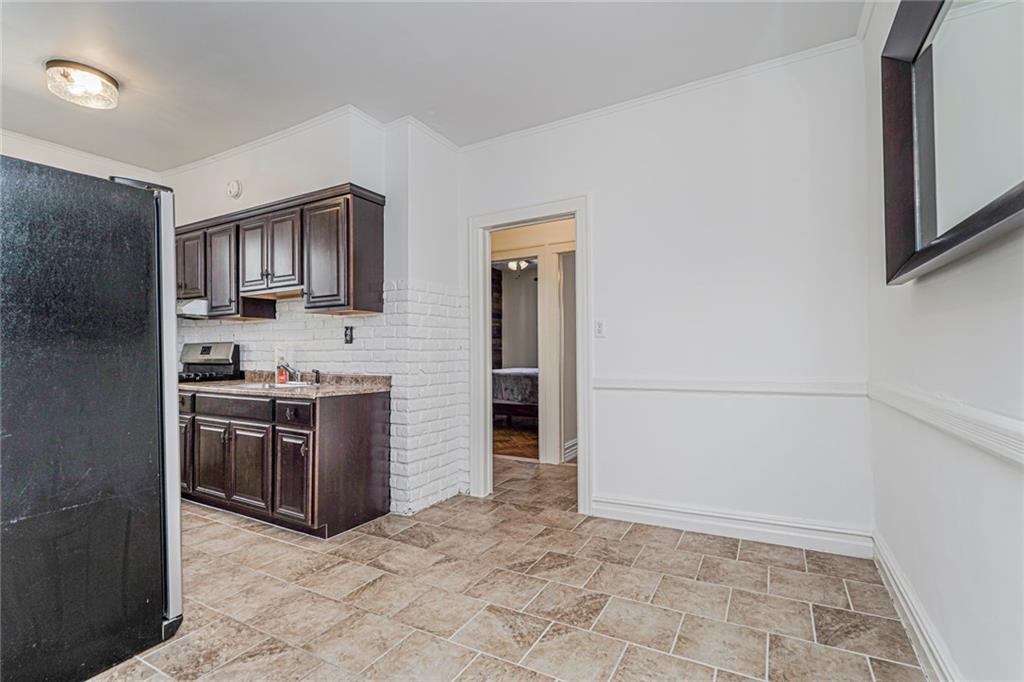 106 Village Road South Brooklyn, NY 11223 - Photo 27 of 42 a view of kitchen with stainless steel appliances granite countertop a stove top oven a sink and dishwasher