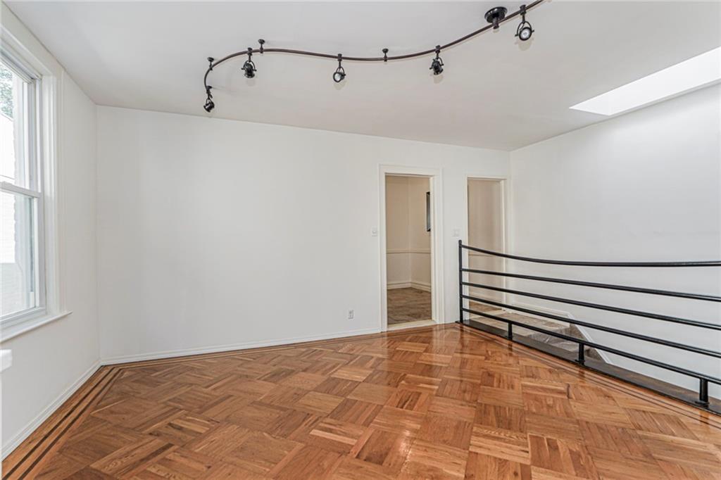 106 Village Road South Brooklyn, NY 11223 - Photo 28 of 42 a view of a room with wooden floor and windows
