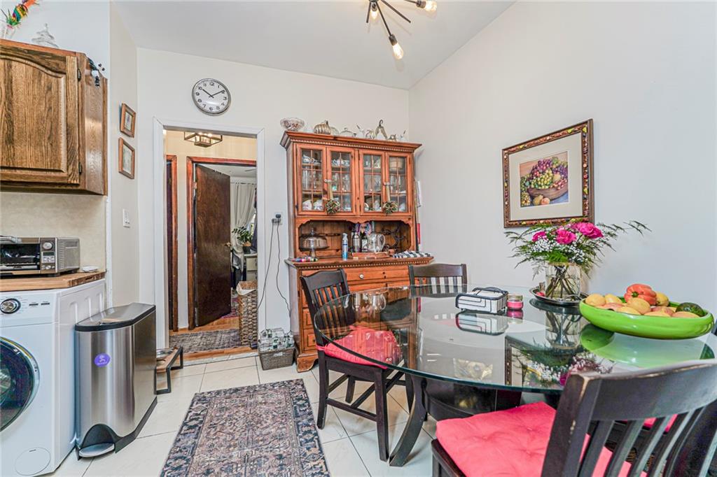 106 Village Road South Brooklyn, NY 11223 - Photo 34 of 42 a living room with furniture toys and a flat screen tv
