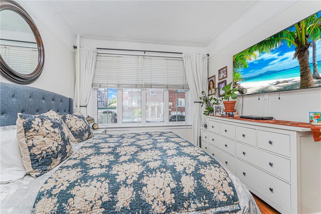 106 Village Road South Brooklyn, NY 11223 - Photo 39 of 42 a bedroom with a large bed and a flat screen tv