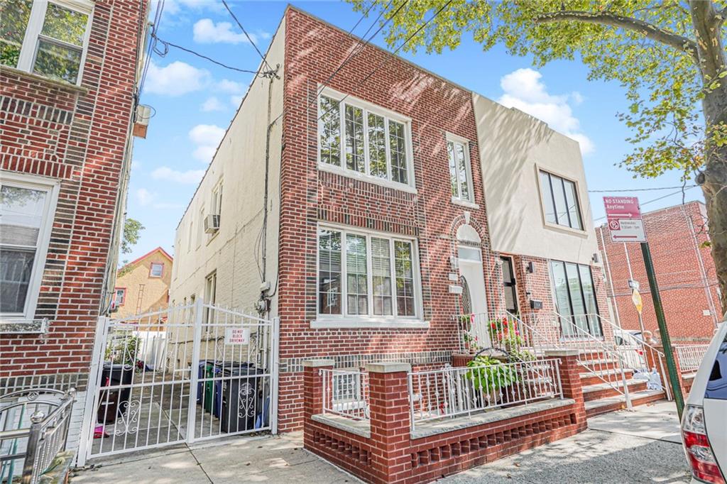 106 Village Road South Brooklyn, NY 11223 - Photo 4 of 42 a view of a brick house with large windows