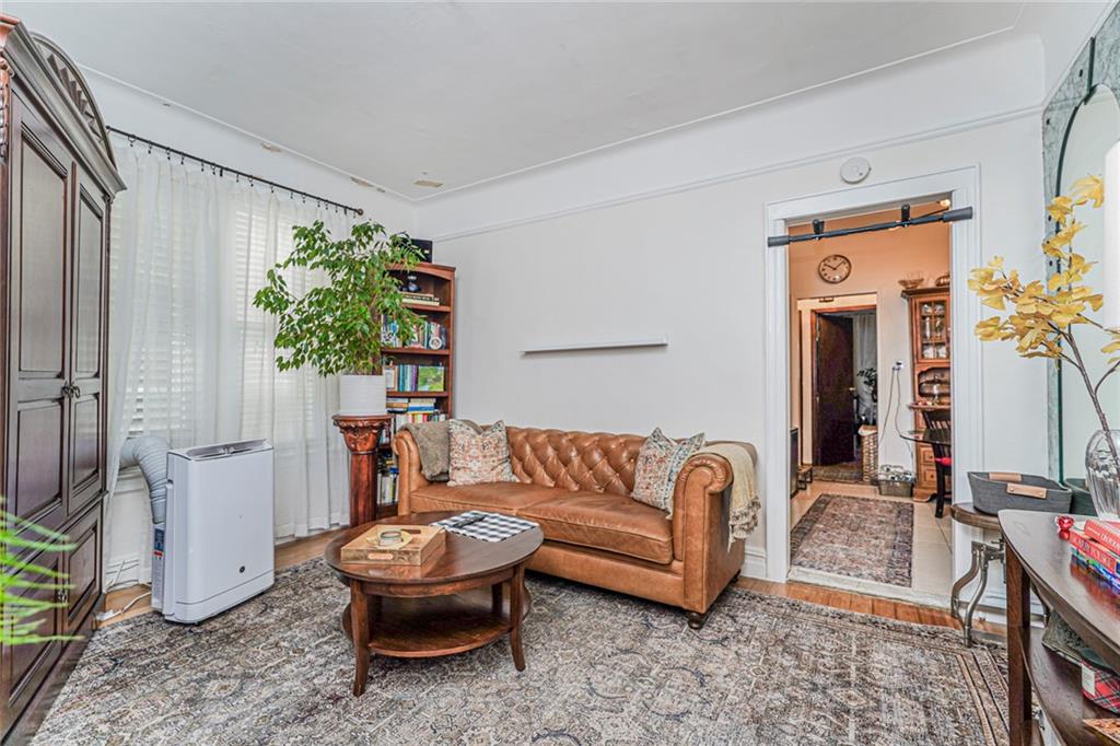 106 Village Road South Brooklyn, NY 11223 - Photo 41 of 42 a living room with furniture and a potted plant