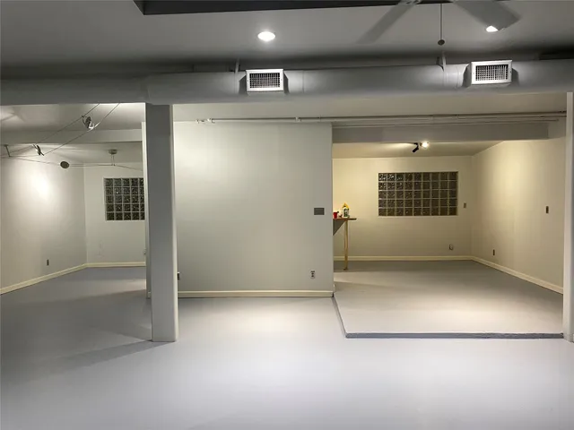 an empty room with a empty space and windows