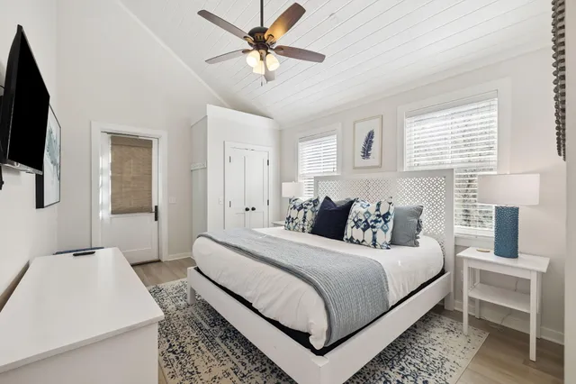 a bedroom with a bed and a flat tv screen on the dresser