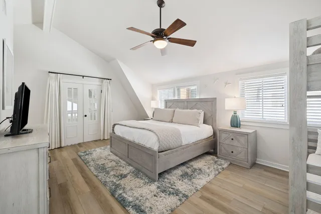 a bedroom with a bed flat screen tv and a couch