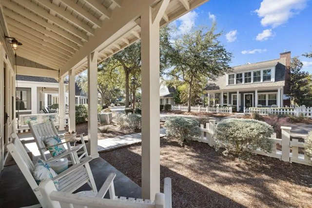 a front view of house with yard outdoor seating and covered with trees