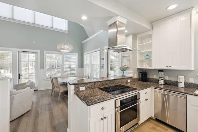 a kitchen with a sink stove cabinets and refrigerator