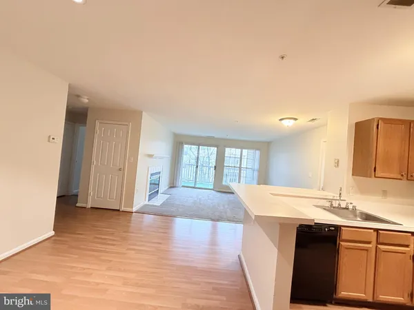 a view of large kitchen with granite countertop cabinets and wooden floor