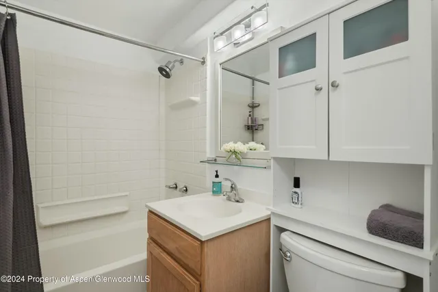 a bedroom with a large bed and a large window