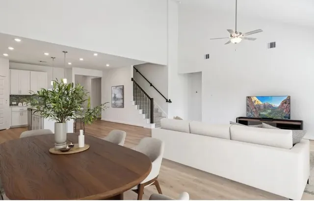 a living room with furniture and a potted plant