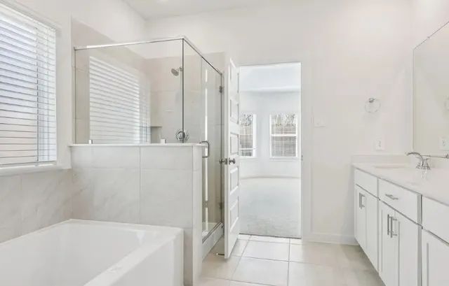 a bathroom with a bathtub a sink and a shower