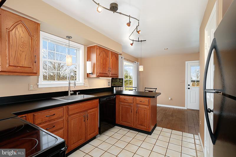 3826 Bark Hill Road Union Bridge, MD 21791 - Photo 8 of 30 a kitchen with stainless steel appliances granite countertop a sink stove and refrigerator