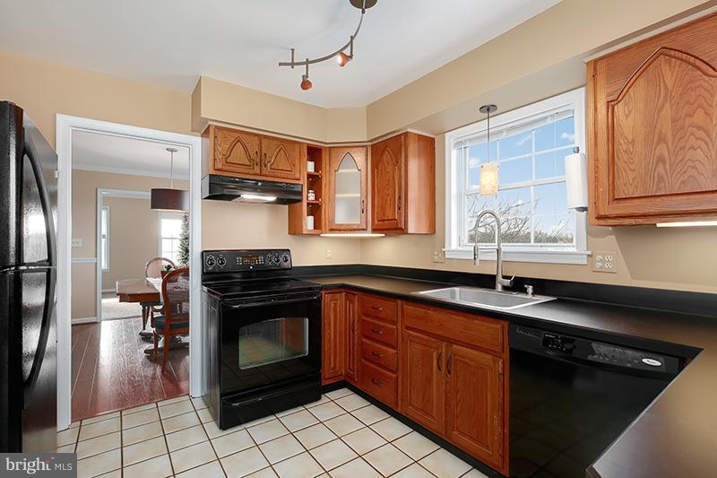 3826 Bark Hill Road Union Bridge, MD 21791 - Photo 9 of 30 a kitchen with stainless steel appliances granite countertop a sink stove and refrigerator