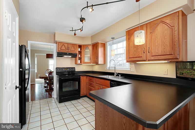 3826 Bark Hill Road Union Bridge, MD 21791 - Photo 10 of 30 a kitchen with stainless steel appliances granite countertop a refrigerator a sink dishwasher a stove and white countertops with wooden floor