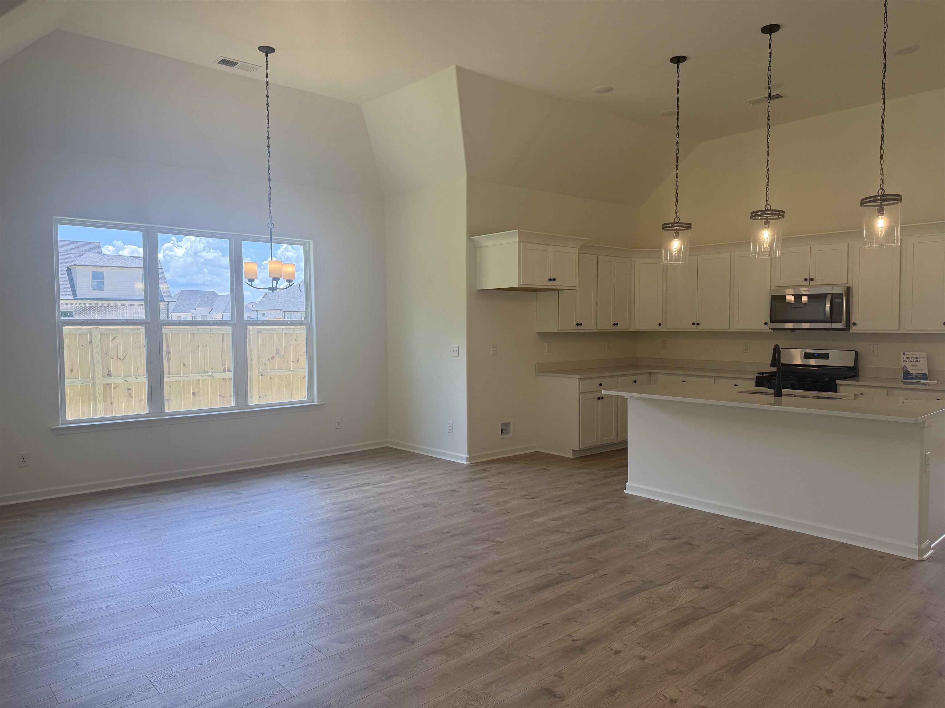 85 Ridgefield Drive Oakland, TN 38060 - Photo 3 of 12 a view of a kitchen with a stove cabinets and a wooden floor