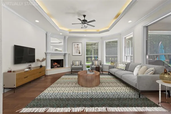 a living room with furniture a flat screen tv and a fireplace