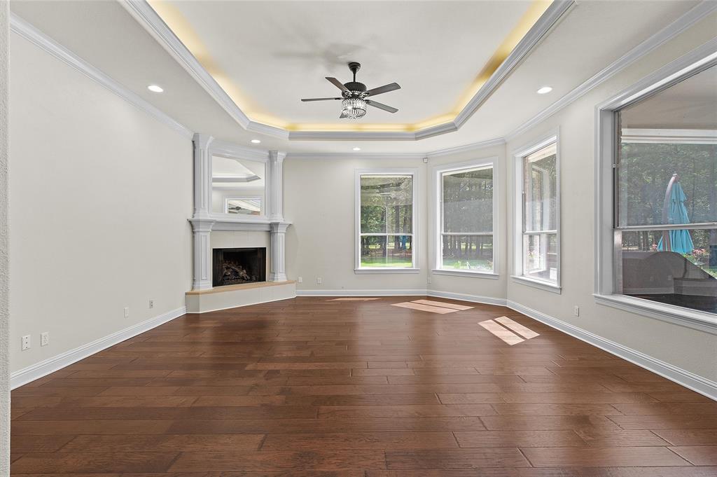 2584 Butler Hill Road Benton, LA 71006 - Photo 13 of 37 an empty room with wooden floor fireplace and windows