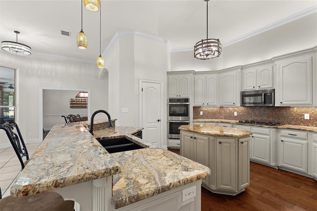2584 Butler Hill Road Benton, LA 71006 - Photo 16 of 37 a kitchen with stainless steel appliances granite countertop a sink a stove center island and cabinets