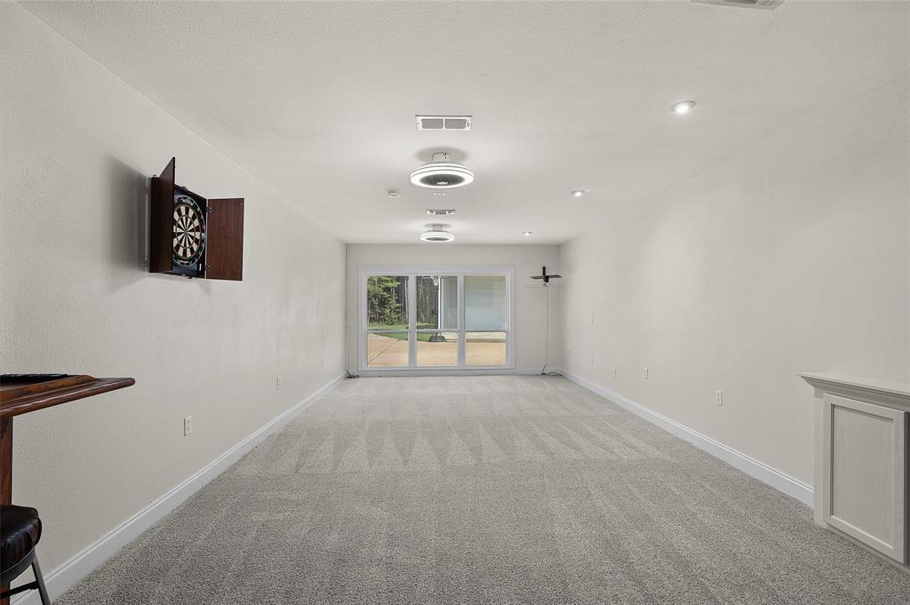 2584 Butler Hill Road Benton, LA 71006 - Photo 19 of 37 a view of an empty room with a window and a flat screen tv