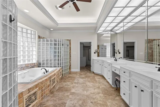 a large white bathroom with a large tub sink shower and mirror