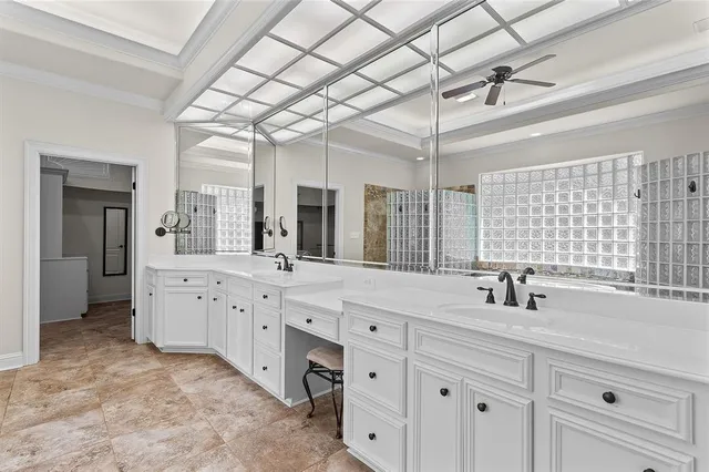 a spacious bathroom with a double vanity sink mirror and shower