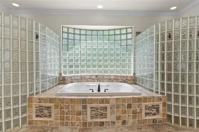 a bathroom with a bathtub and a shower
