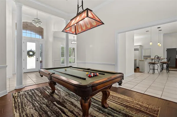 a living room with furniture a table and kitchen view