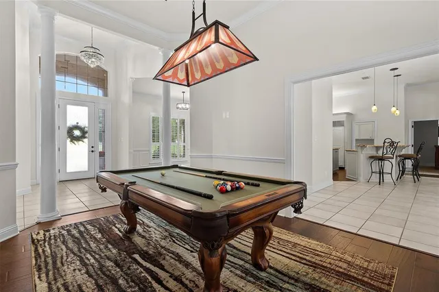 a living room with furniture a table and kitchen view