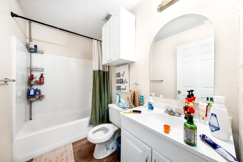 701 Southwest 1st Street Cooper, TX 75432 - Photo 17 of 22 a bathroom with a sink a toilet and a shower