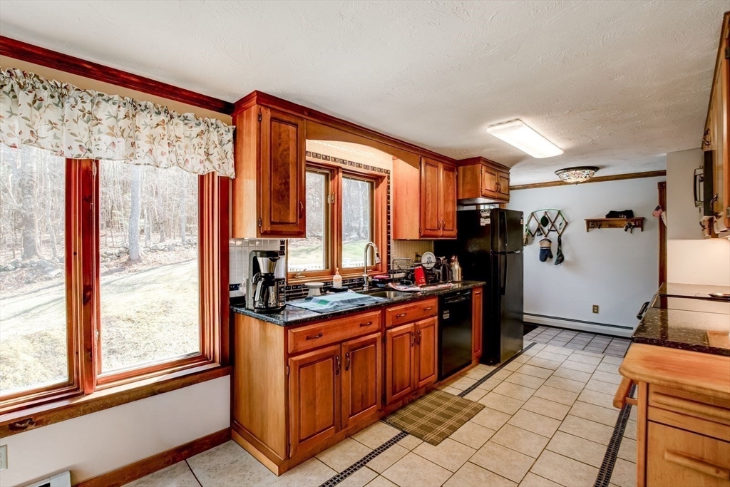 205 East Rindge Road Ashburnham, MA 01430 - Photo 17 of 40 a kitchen with stainless steel appliances granite countertop a stove a sink and a refrigerator