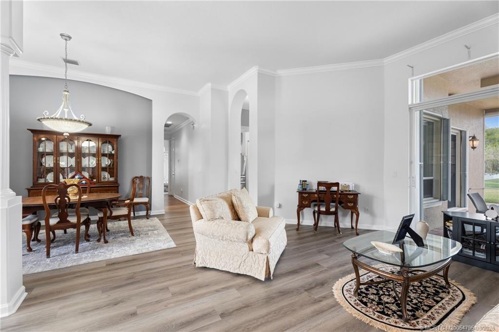 758 Southwest Blue Stem Way Stuart, FL 34997 - Photo 11 of 49 a living room with furniture and a dining table with wooden floor