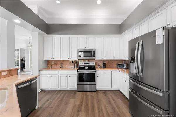 a kitchen with a refrigerator stove and sink