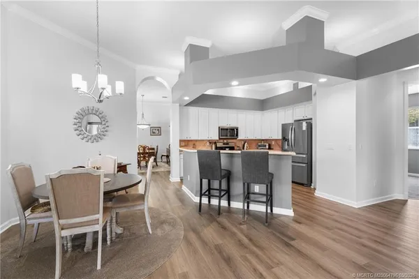 a view of a dining room with furniture and wooden floor