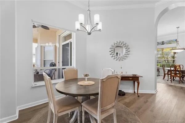 a view of a dining room with furniture and wooden floor