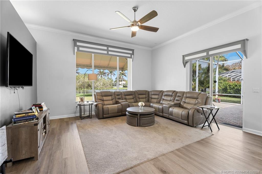758 Southwest Blue Stem Way Stuart, FL 34997 - Photo 18 of 49 a living room with furniture and a flat screen tv