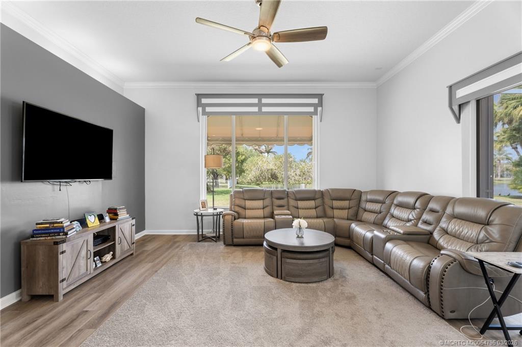 758 Southwest Blue Stem Way Stuart, FL 34997 - Photo 19 of 49 a living room with furniture and a flat screen tv