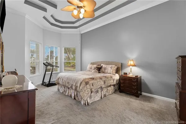 a bedroom with bed and a chandelier