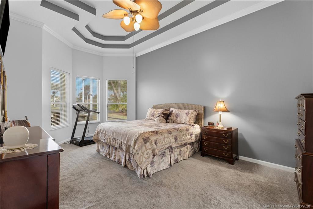 758 Southwest Blue Stem Way Stuart, FL 34997 - Photo 20 of 49 a bedroom with bed and a chandelier
