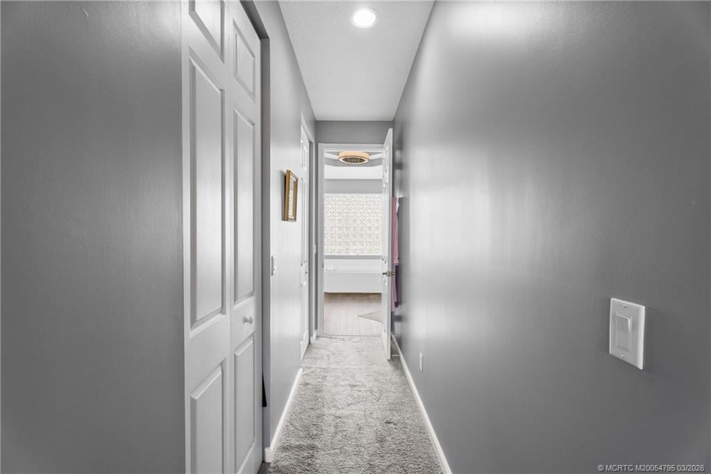 758 Southwest Blue Stem Way Stuart, FL 34997 - Photo 22 of 49 a view of a hallway with wooden floor