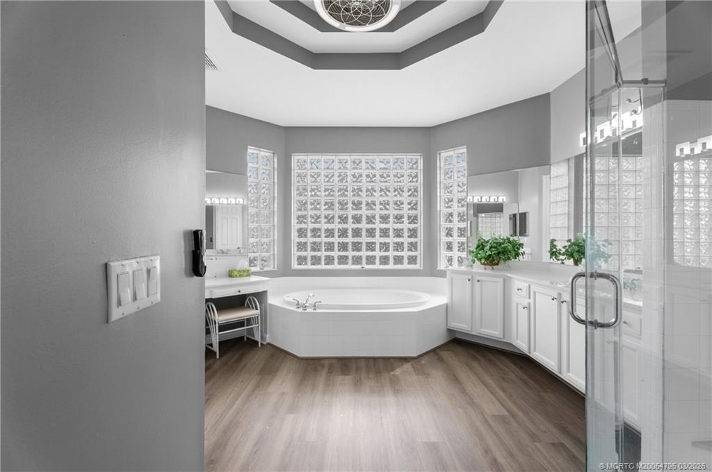 758 Southwest Blue Stem Way Stuart, FL 34997 - Photo 23 of 49 a bathroom with a bathtub a sink and a window