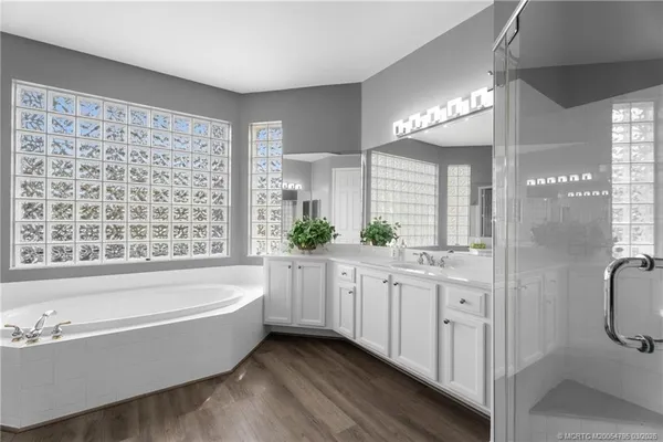 a bathroom with a bathtub a sink and a shower