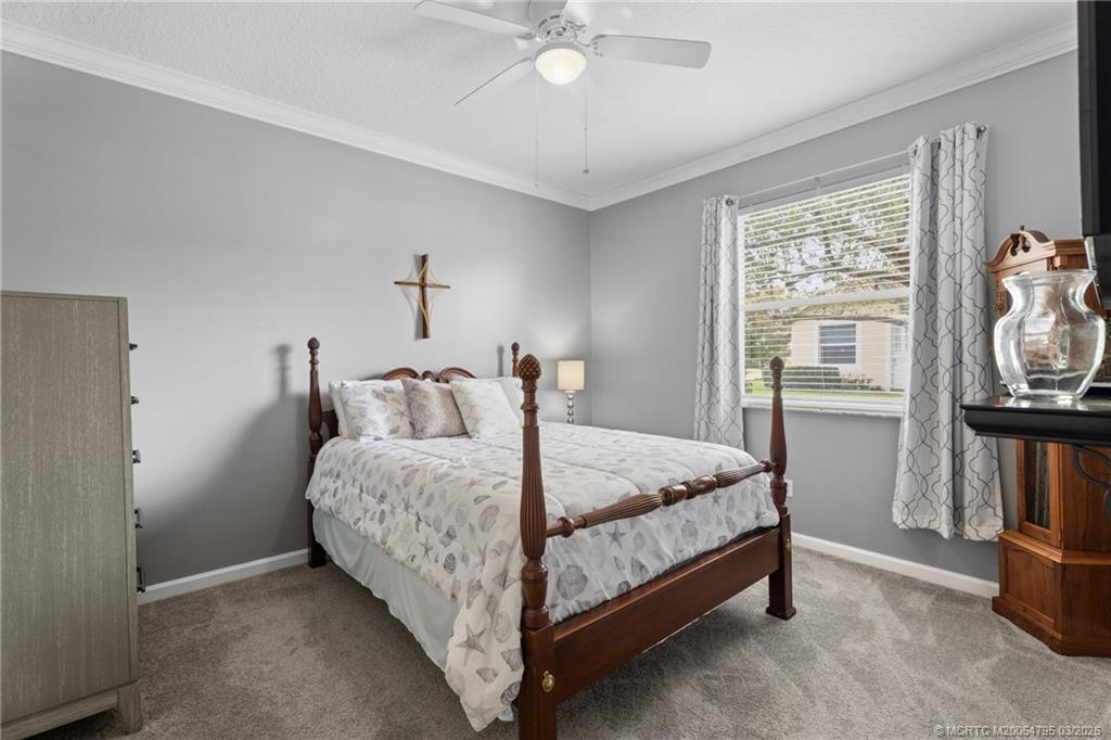 758 Southwest Blue Stem Way Stuart, FL 34997 - Photo 27 of 49 a bed room with a bed and a tv