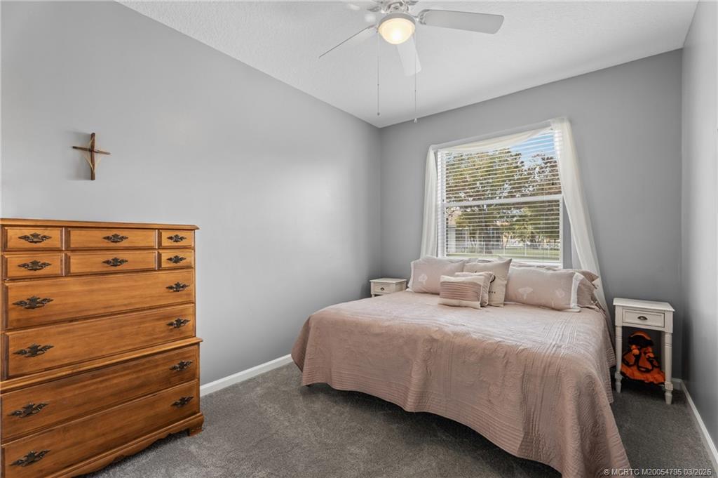 758 Southwest Blue Stem Way Stuart, FL 34997 - Photo 30 of 49 a bedroom with a bed and a window