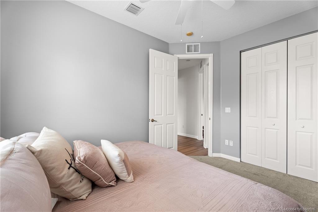 758 Southwest Blue Stem Way Stuart, FL 34997 - Photo 31 of 49 a bedroom with a bed and a window